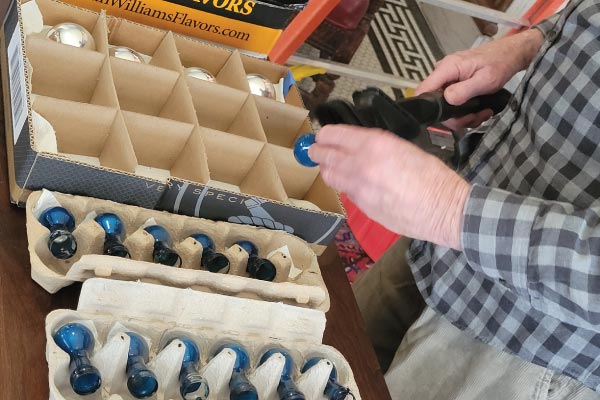 Cleaning each bulb of the American flag at the Penn Wells Hotel